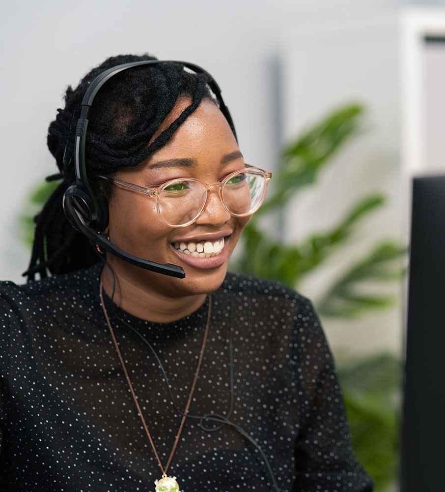 Smiling Debt Tec employee on a call with clients to help with IOD Claims management and to recover bad debt.